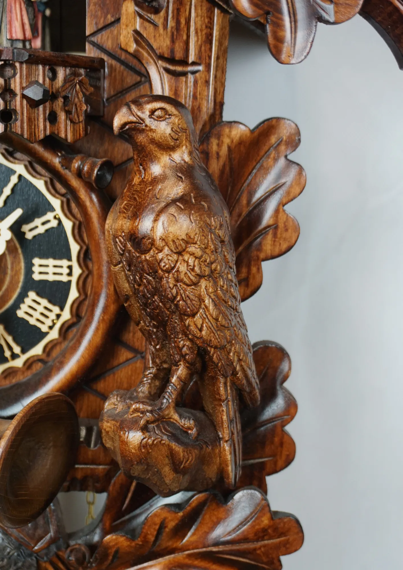 Cuckoo Clock Oak Forest 8 Day Movement with Music (4) Authentic traditional brown mechanical black forest cuckoo clock decorated with oak leaves, majestic eagle, rabbit and a falcon. The dancers dance as the music is being played. Made by Hönes