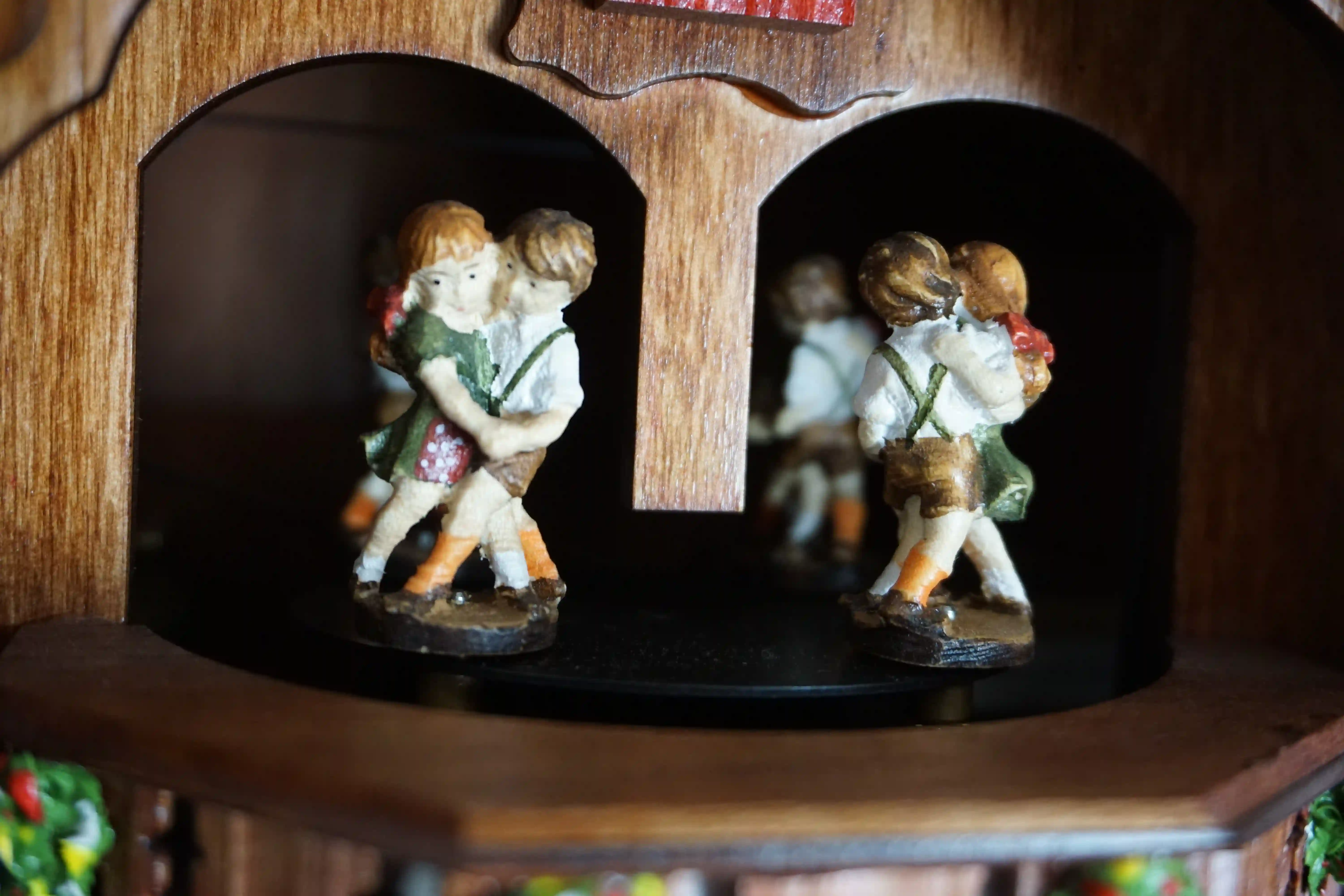 Cuckoo Clock Kissing Kids 8 Day Movement with Music (8) Chalet shingle roof mechanical black forest cuckoo clock with presice attention to detail. The kids are turning their heads and kissing, water wheel turns and the dancers are dancing as the music is playing