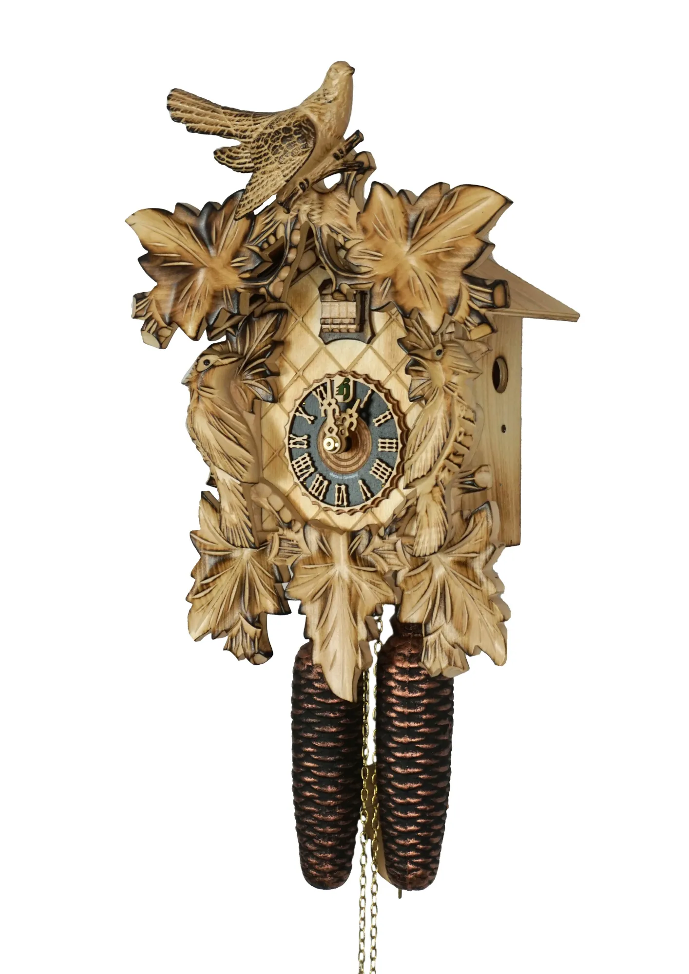 Cuckoo Clock Natural Color Wood 8 Day Movement (2) Middle sized traditional hand carved beige mechanical cuckoo clock decorated with wine leaves and with three birds with 8 days mechanism, the clock is preserved in its natural wood color, made by Hönes