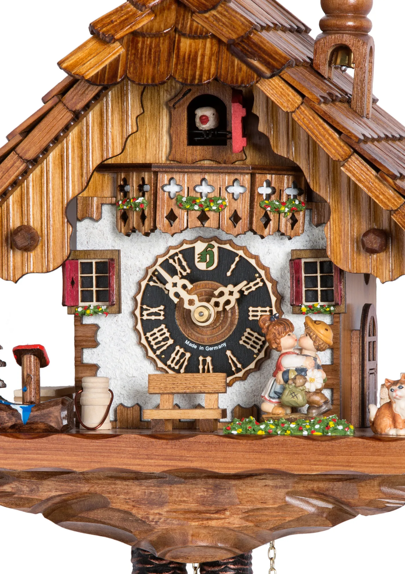 Cuckoo Clock Kissing Kids 1 Day Movement (2) This cute colorful mechanical cuckoo clock shows a lovely scene of a boy and girl kissing in front of the Black Forest chalet house. Shingle roof, tower bell, solid base and the kitty really show the attention to detail on this clock.
